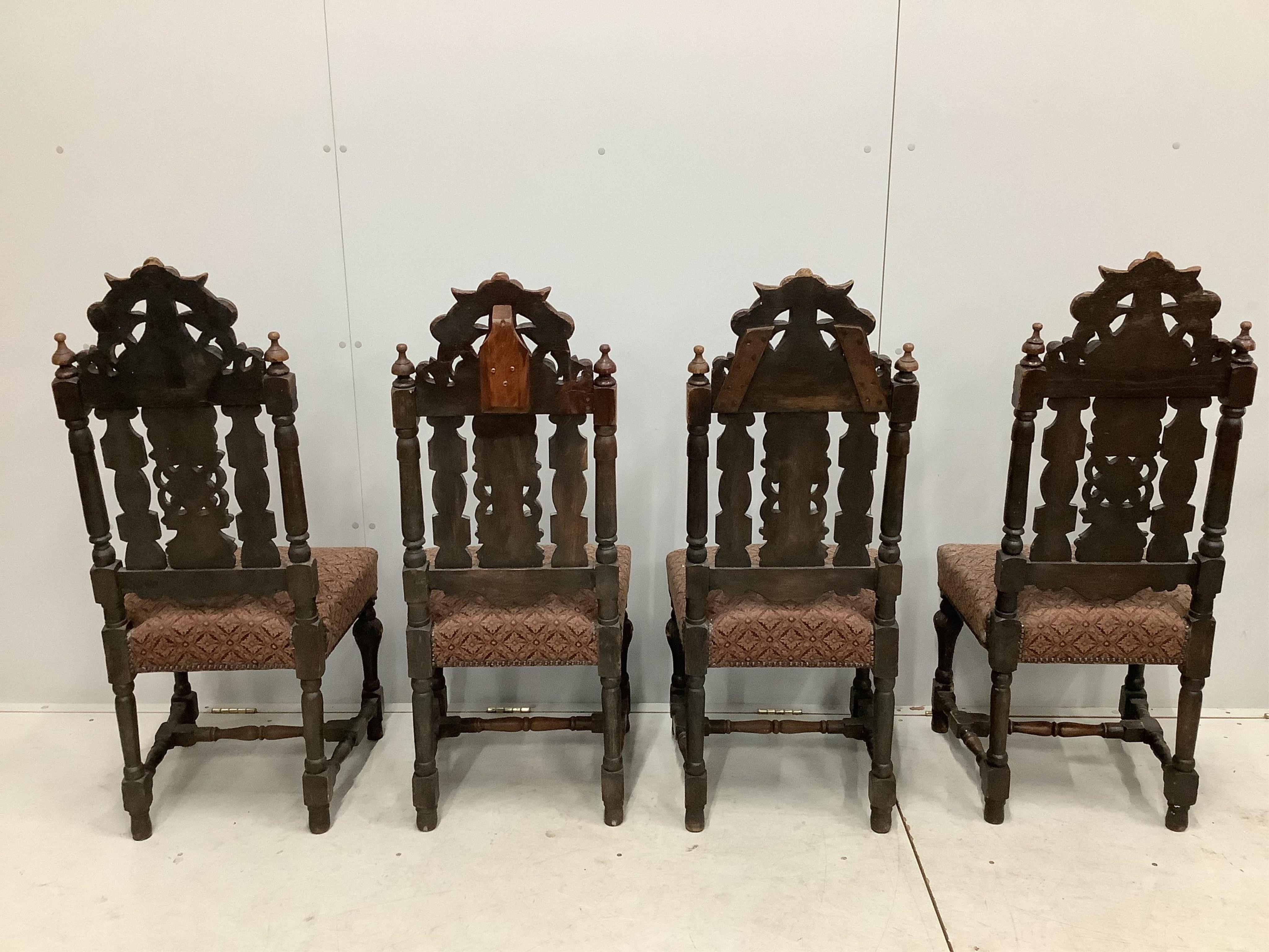 A set of thirteen carved Victorian oak dining chairs, one with arms. Condition - poor to fair